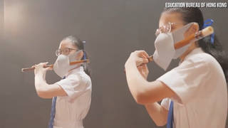 Two masked flute players in a Hong Kong propaganda video.