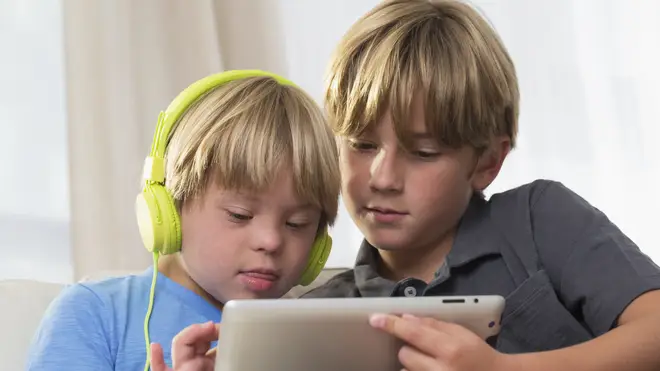 Down syndrome boy using tablet