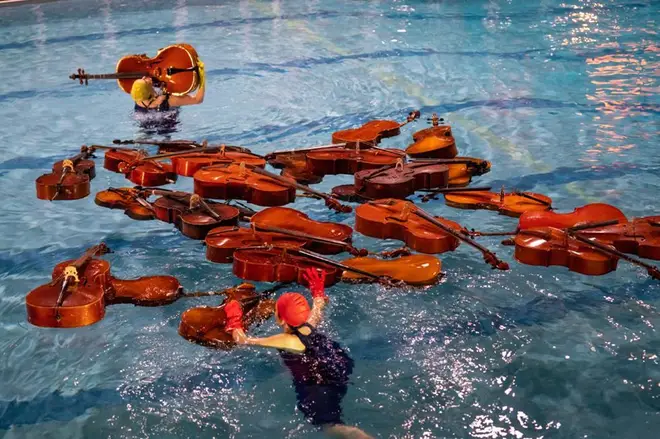 30 cellos in a swimming pool