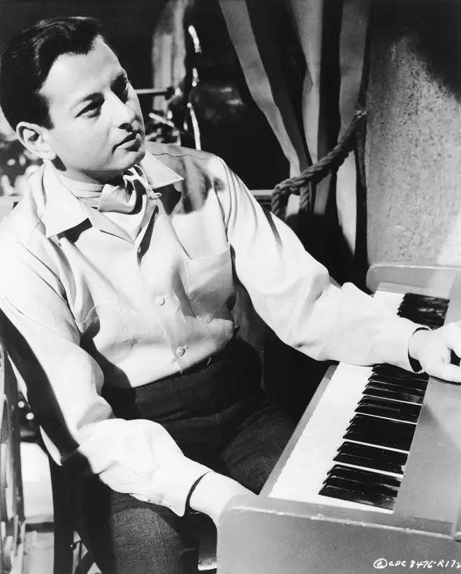 A young André Previn sits at a keyboard