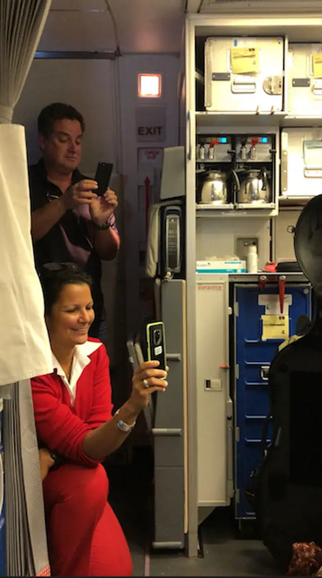 Flight attendant films cellist on board an Austrian Airlines flight.