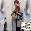 Violinist Boglarka Gyorgy plays with a washing machine