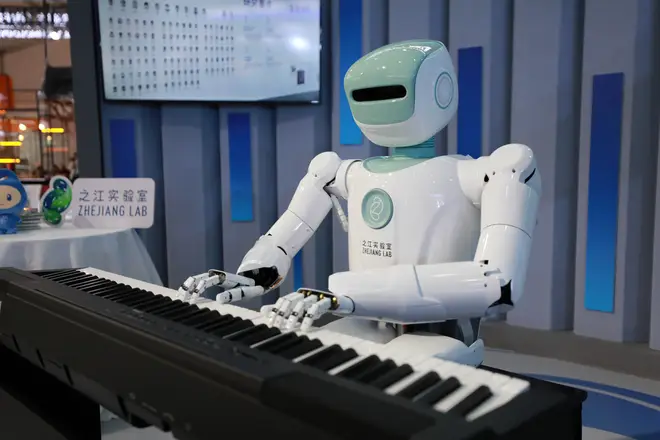 A robot by Zhejiang Lab plays the piano after analysing audience’s characters during the Apsara Conference 2021