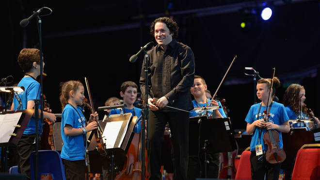 Maestro Gustavo Dudamel conducts the children from the Big Noise Orchestra during the Big Concert on June 21, 2012 in Stirling, Scotland