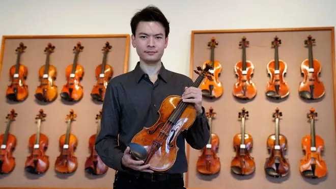 Violinist Stefan Jackiw poses with Giuseppe Guarneri del Gesu's c.1731 ‘Baltic’ violin at Tarisio Auctions on March 9, 2023, in New York