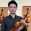 Violinist Stefan Jackiw poses with Giuseppe Guarneri del Gesu's c.1731 "Baltic" violin at Tarisio Auctions on March 9, 2023, in New York