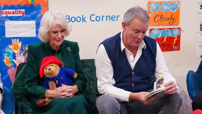 Hugh Bonneville and Queen Consort Camilla read Paddington Bear to children supported by the charity Barnados in November 2022.