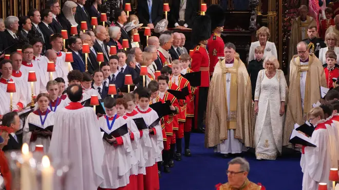 The girl choristers of Methodist College in Belfast are visible within the choir standing in the left choir stalls wearing their school uniforms.