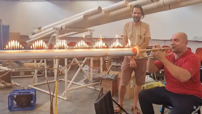 Moises Alves demonstrates sound waves using a metal tube, a trumpet, and 100 tiny flames.