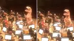 T-Rex conducts symphony orchestra in an ultra-realistic performance of ‘Jurassic Park’