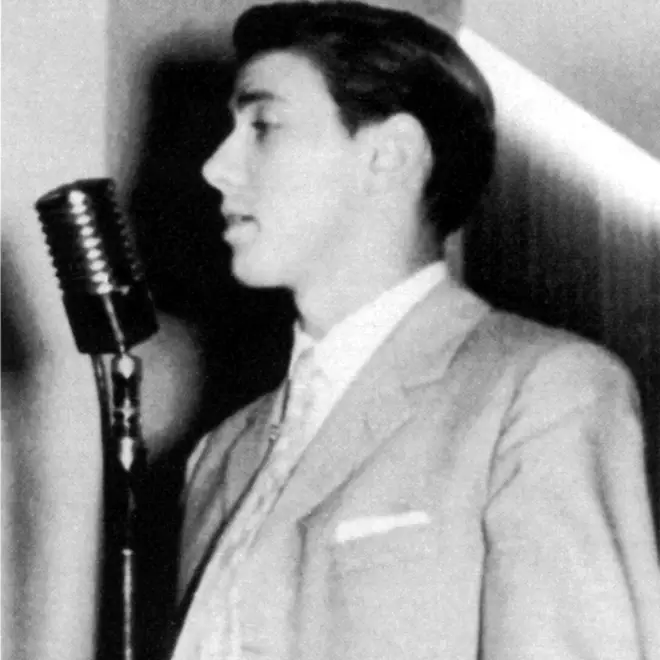Aged 17, Berlusconi sings on stage at a microphone