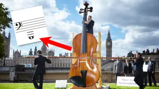 Very big violin takes three people to play it