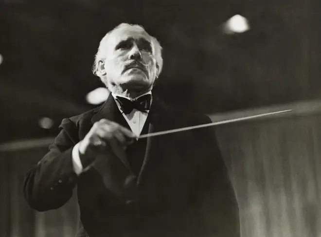 Conductor Arturo Toscanini directing an orchestra