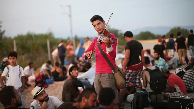 Rami Basisah, a 24-year-old violinist, plays after fleeing from his home