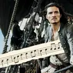 Who wrote the music for Pirates of the Caribbean, and what is the iconic theme?