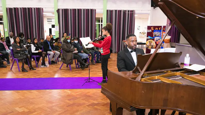 Nimai Walcott playing piano at a school concert