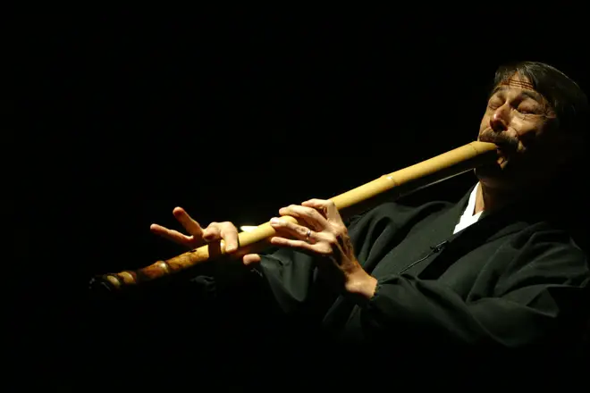 Composer Riley Lee playing the Japanese flute, the Shakuhachi