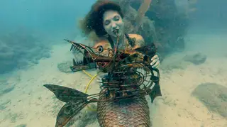 Scuba diver plays music underwater