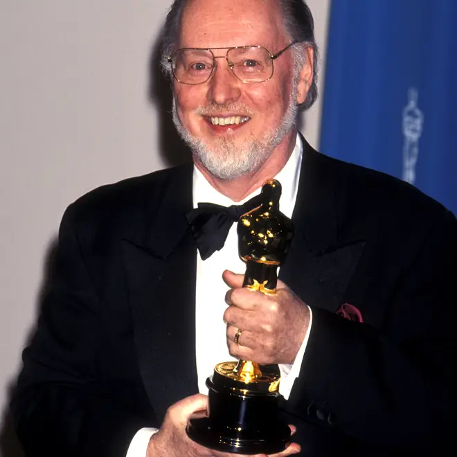 John Williams holding his 1994 Oscar for Schindler's List