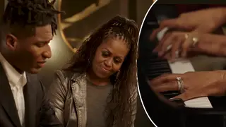 Michelle Obama and Jon Batiste play a duet at the piano.