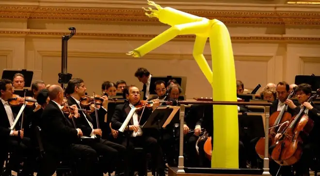 Inflatable man conducts an orchestra