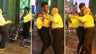 Old man dances on the streets of Madrid as busker sings jazz