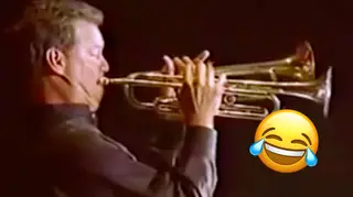 Guy plays two trumpets at the same time