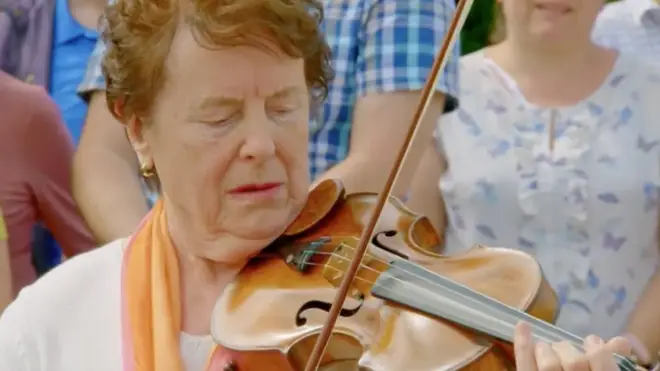 Antiques Roadshow guest playing her violin