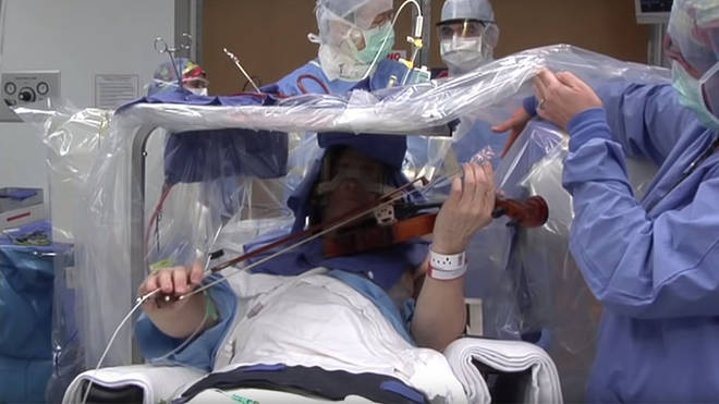 Roger Frisch carries on playing violin during brain surgery